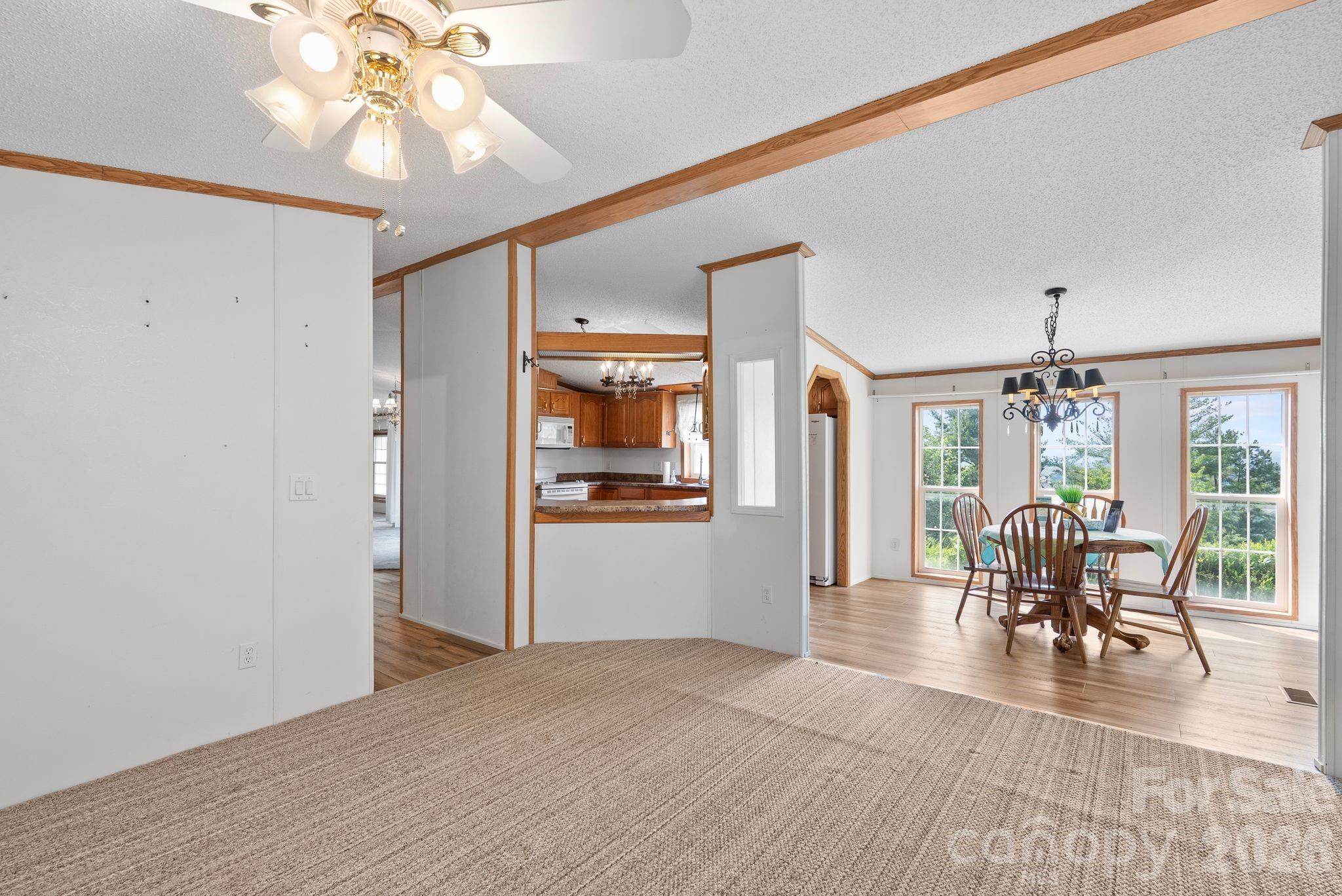 133 Spivey Mountain Road Asheville, NC 28806 - Photo 5 of 40 a view of a dining room with furniture window and wooden floor