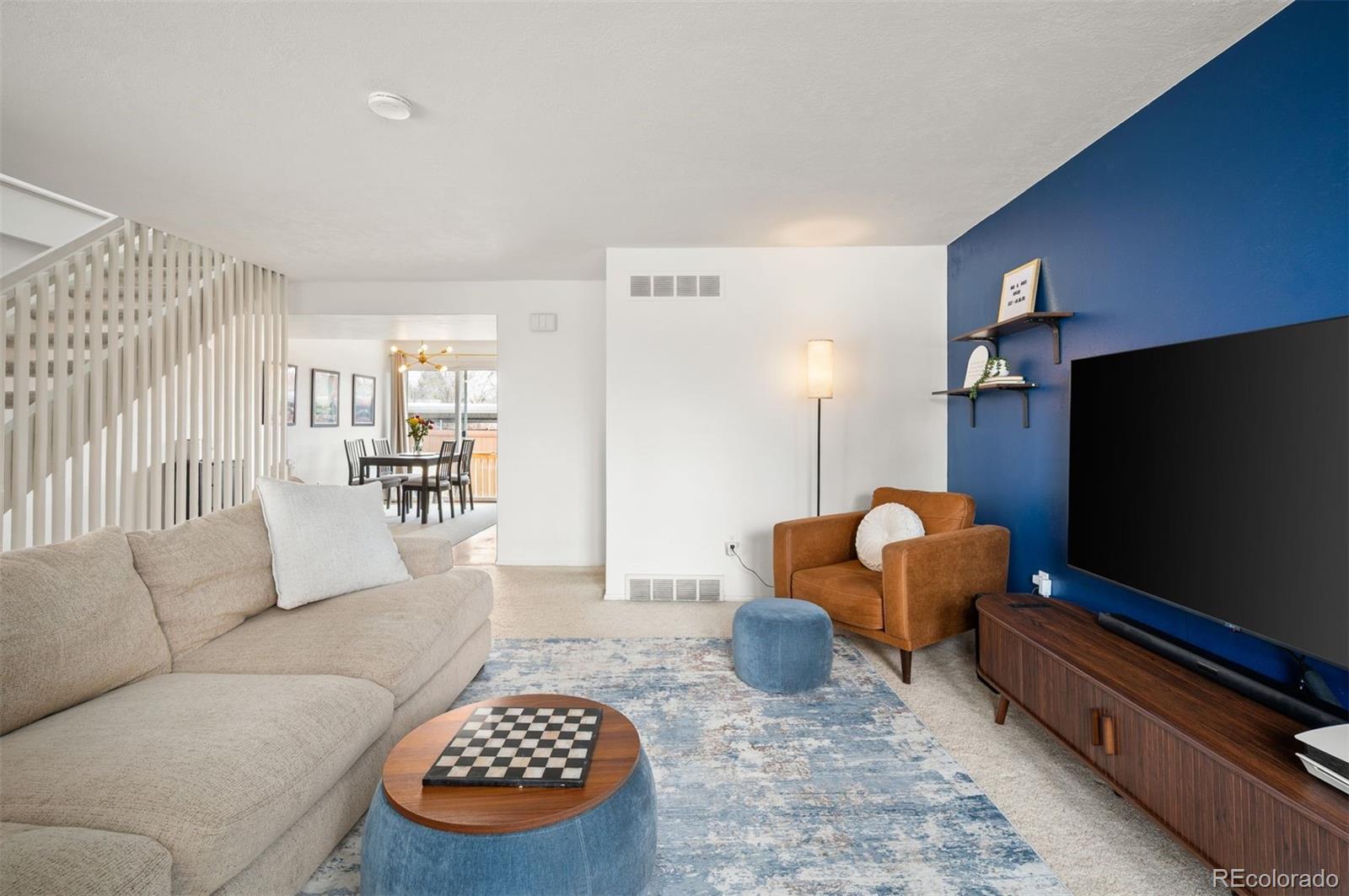 4367 East Maplewood Way Centennial, CO 80121 - Photo 11 of 26 a living room with furniture and a flat screen tv