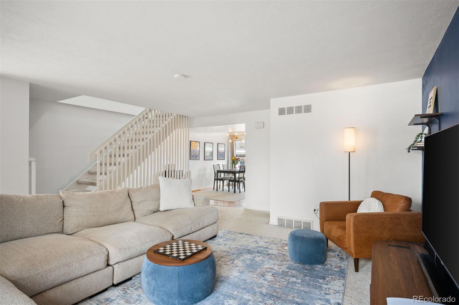 4367 East Maplewood Way Centennial, CO 80121 - Photo 12 of 26 a living room with furniture and a lamp