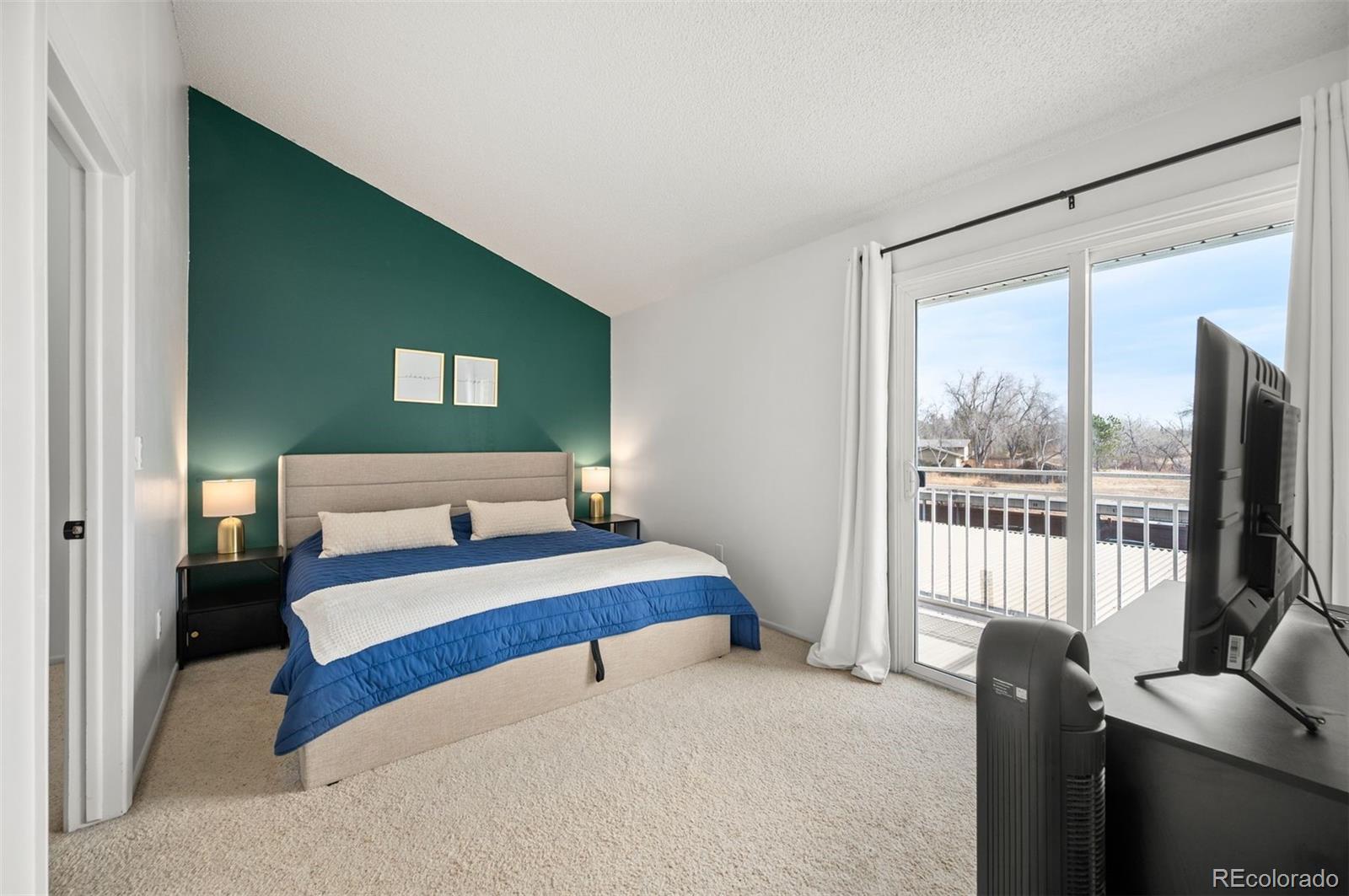 4367 East Maplewood Way Centennial, CO 80121 - Photo 14 of 26 a bedroom with a bed and glass window