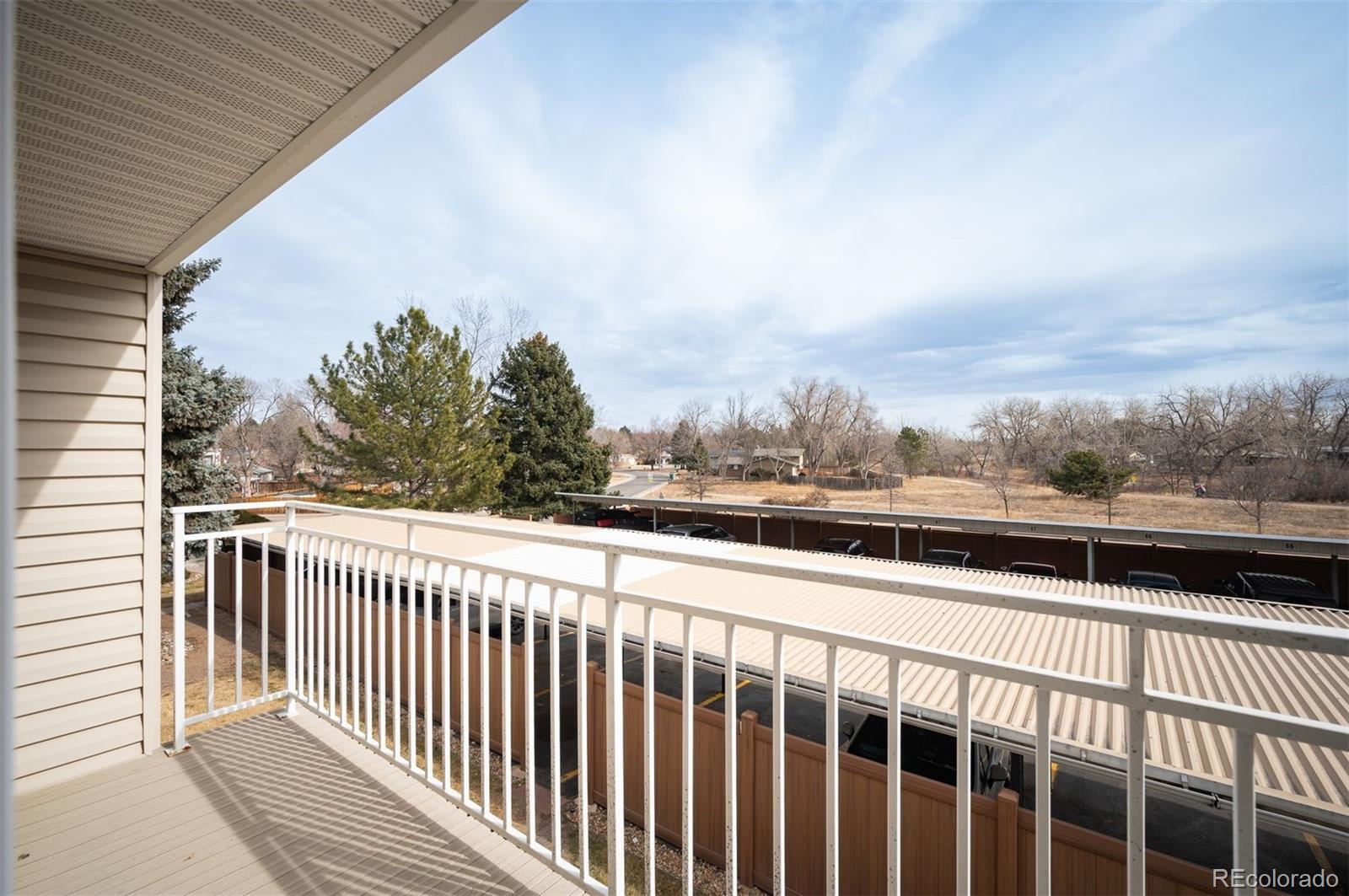 4367 East Maplewood Way Centennial, CO 80121 - Photo 16 of 26 a view of a balcony with wooden fence