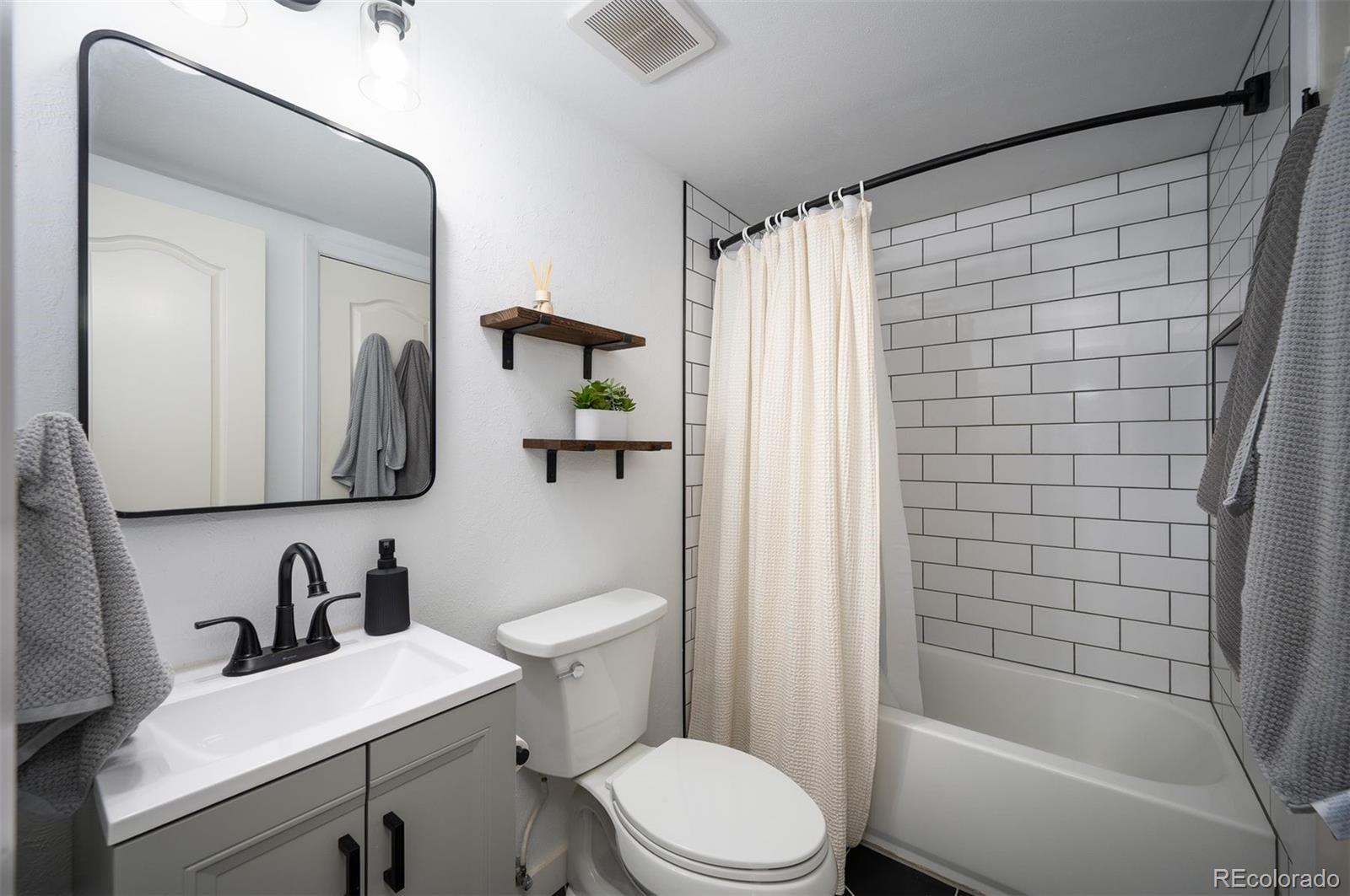 4367 East Maplewood Way Centennial, CO 80121 - Photo 17 of 26 a bathroom with a sink toilet and shower