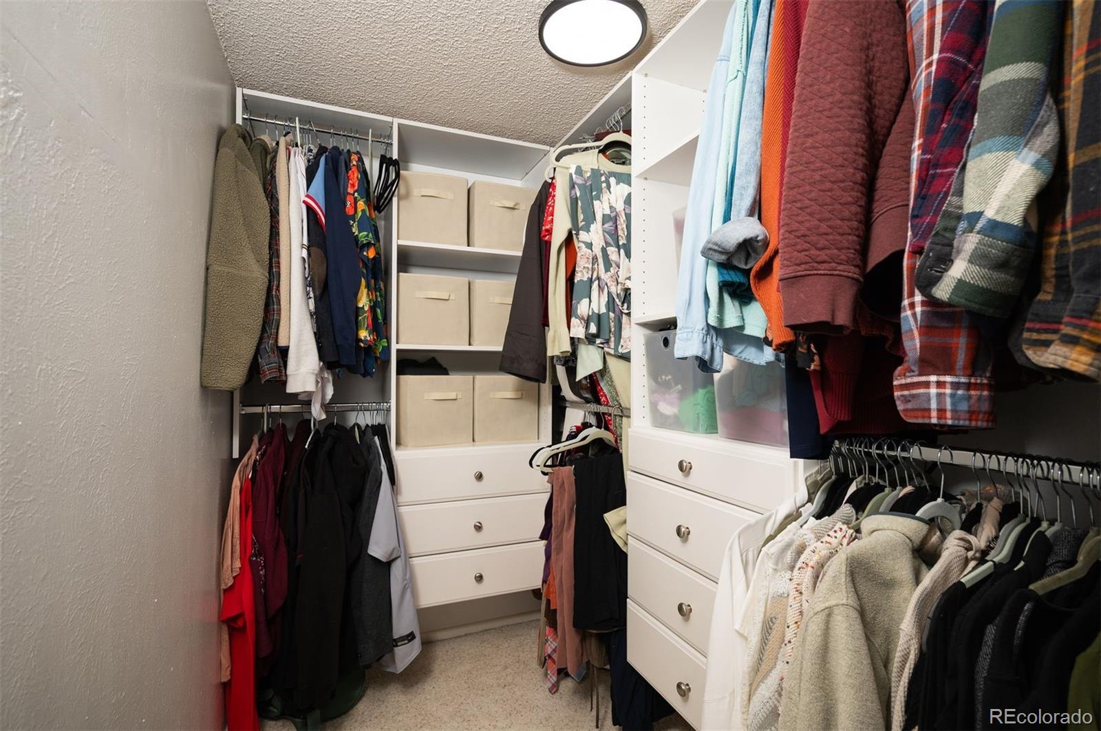 4367 East Maplewood Way Centennial, CO 80121 - Photo 18 of 26 a view of walk in closet with clothes and shoes