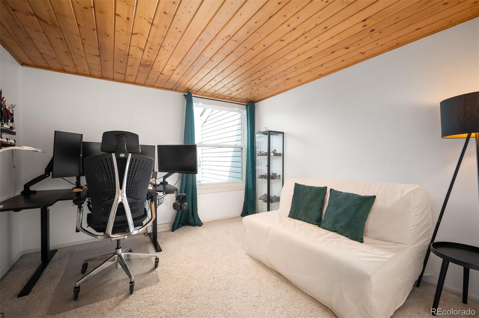 4367 East Maplewood Way Centennial, CO 80121 - Photo 19 of 26 a bedroom with furniture a window and gym cycle