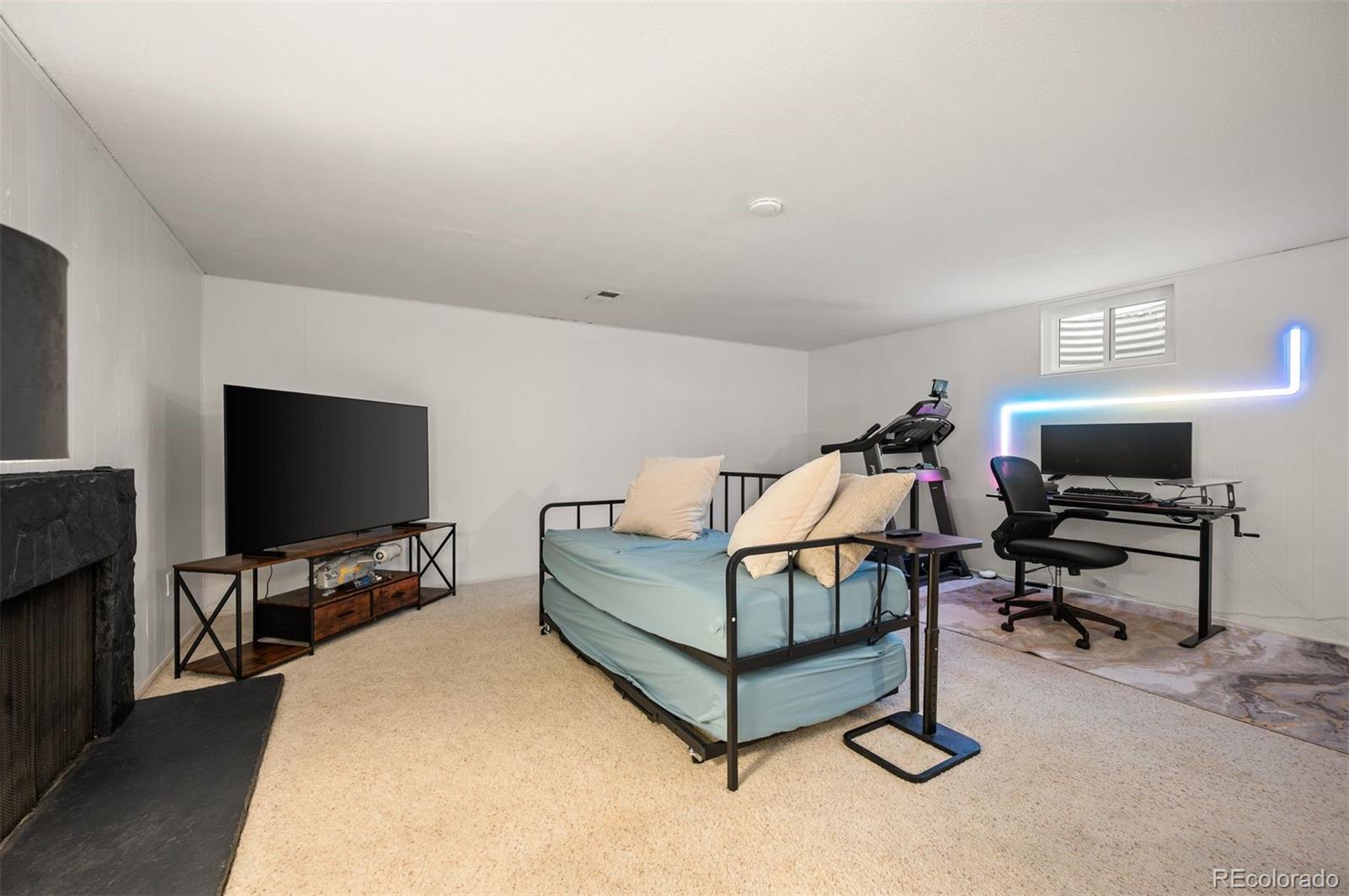 4367 East Maplewood Way Centennial, CO 80121 - Photo 23 of 26 a living room with furniture and a flat screen tv