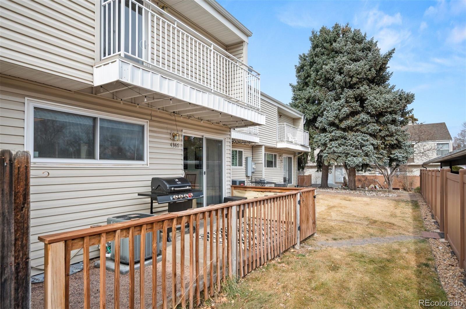4367 East Maplewood Way Centennial, CO 80121 - Photo 24 of 26 a view of a house with a wooden fence