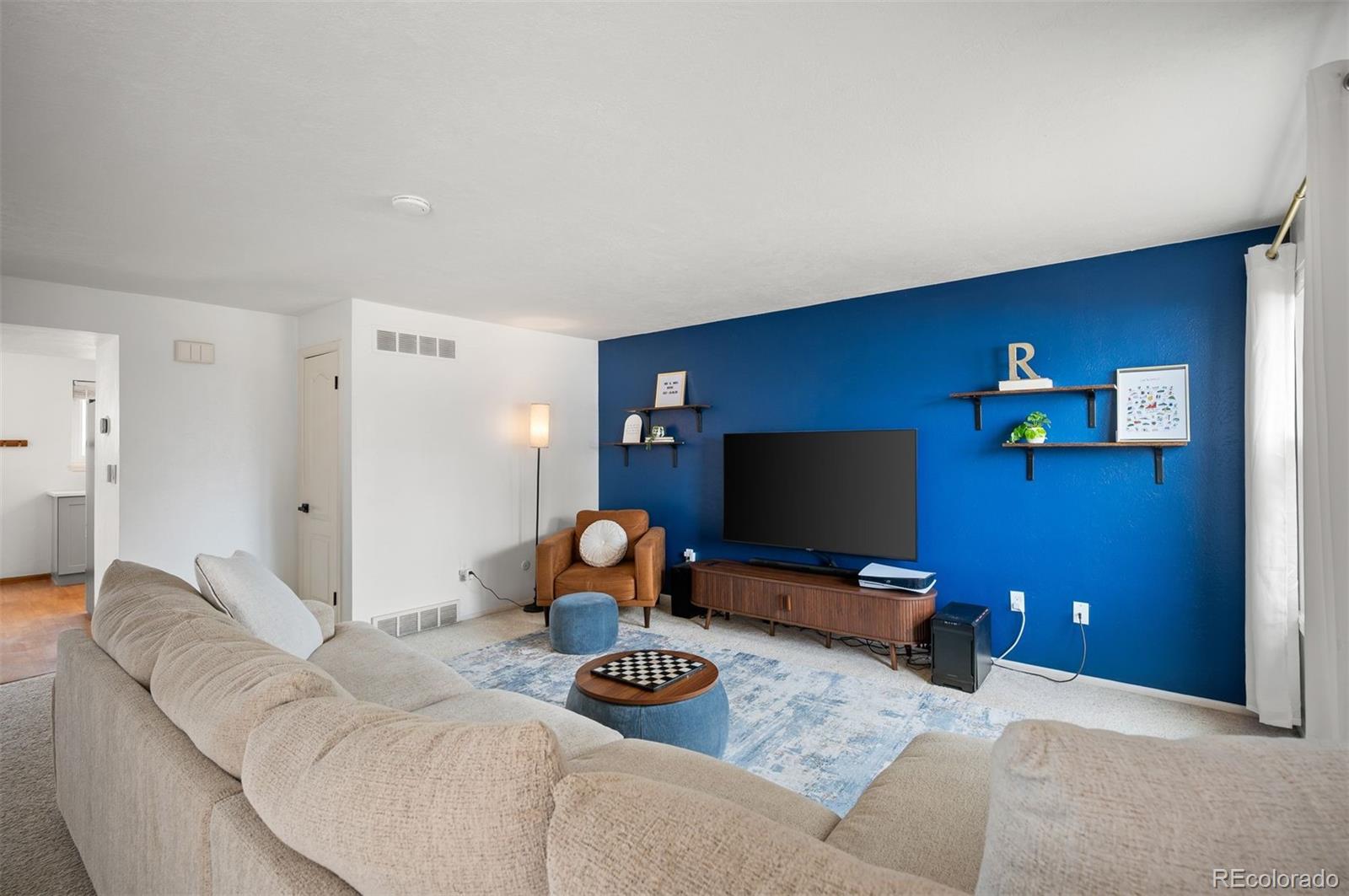 4367 East Maplewood Way Centennial, CO 80121 - Photo 10 of 26 a living room with furniture and a flat screen tv