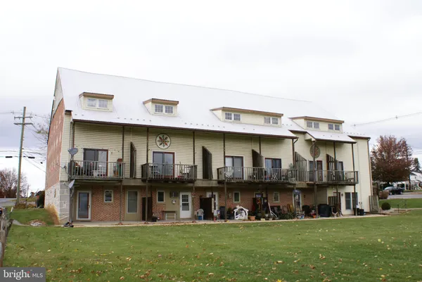 a view of a large building with a yard
