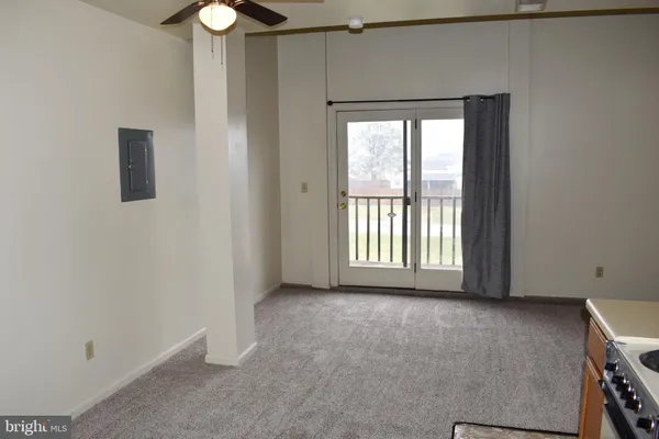 a view of an empty room with a window