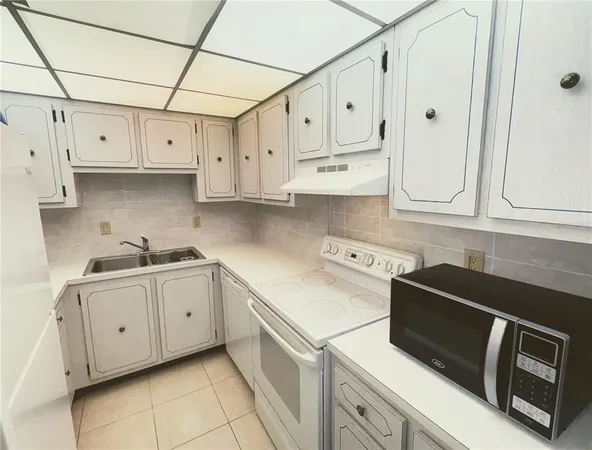 a kitchen with stainless steel appliances granite countertop white cabinets sink and dishwasher