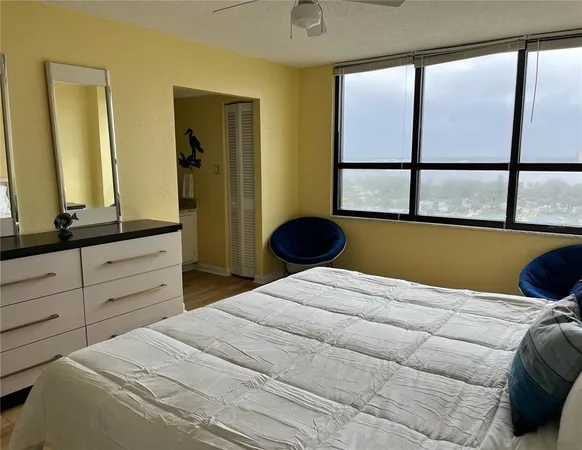 a bedroom with a bed and a large window