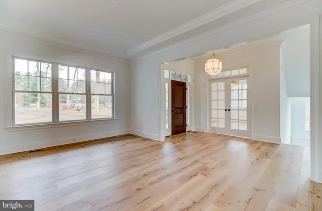 a kitchen with a sink cabinets and wooden floor