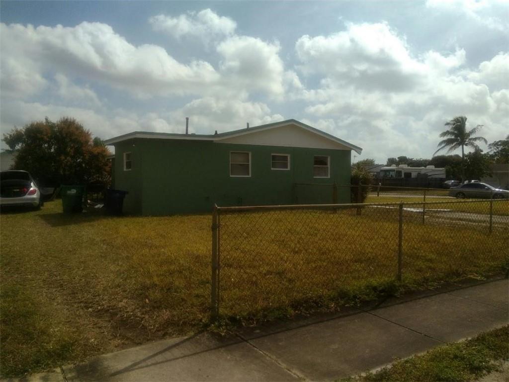 2951 Northwest 208th Terrace Miami Gardens, FL 33056 - Photo 9 of 10 a front view of a house with a yard