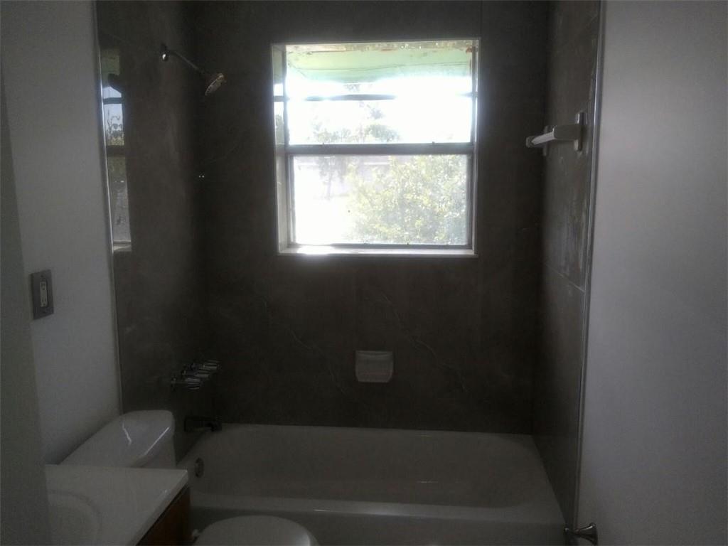 2951 Northwest 208th Terrace Miami Gardens, FL 33056 - Photo 10 of 10 a bathroom with a toilet and a window