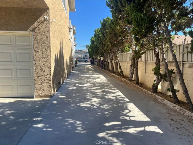 a view of a pathway of a house with a tree