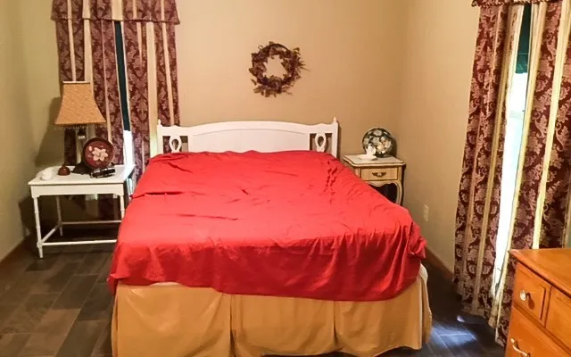 a bed sitting in a bedroom next to a window