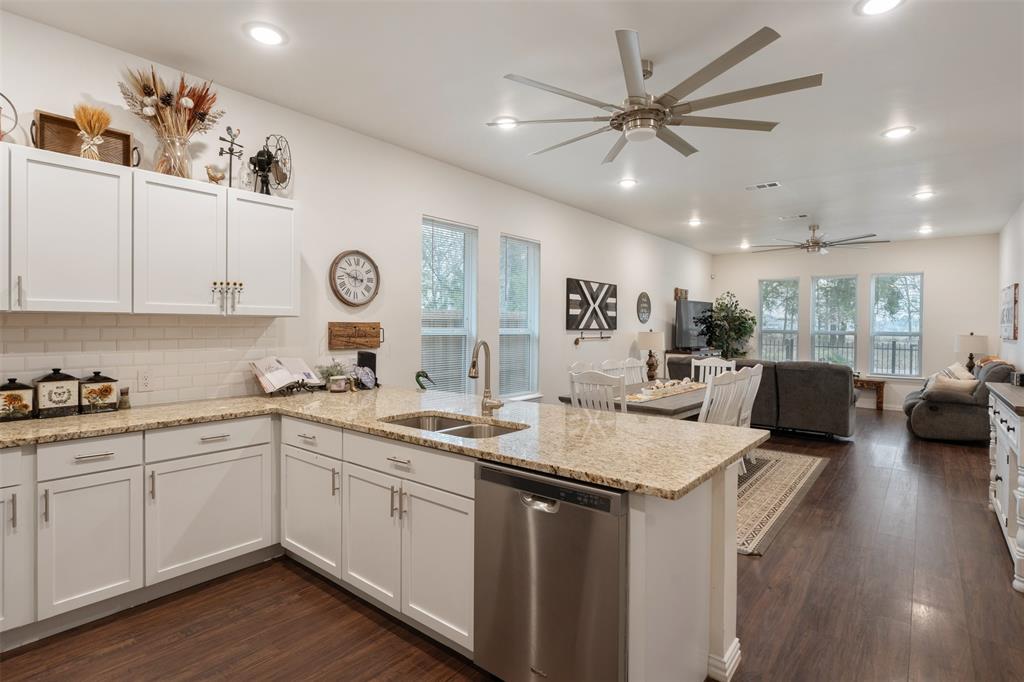 6156 Inca Drive Mabank, TX 75156 - Photo 13 of 30 a open kitchen with stainless steel appliances granite countertop a sink dishwasher a stove with white cabinets and wooden floor