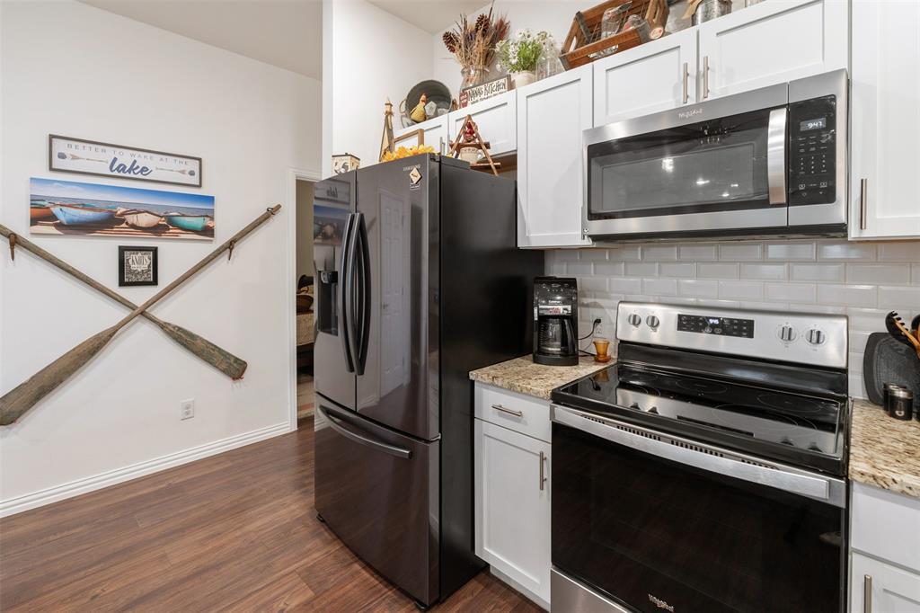 6156 Inca Drive Mabank, TX 75156 - Photo 15 of 30 a kitchen with stainless steel appliances and wooden cabinets