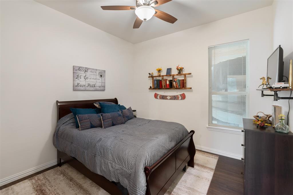 6156 Inca Drive Mabank, TX 75156 - Photo 16 of 30 a bedroom with a large bed and a chandelier