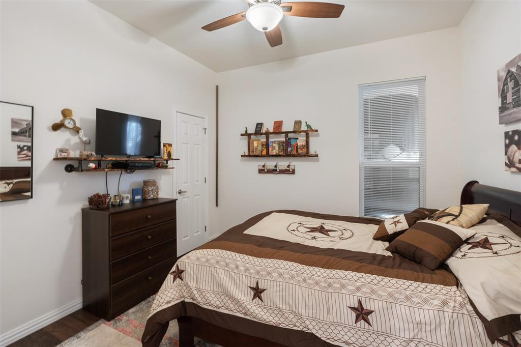 6156 Inca Drive Mabank, TX 75156 - Photo 17 of 30 a bedroom with a bed and a flat screen tv