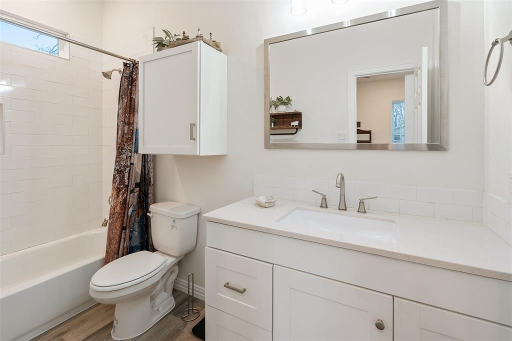 6156 Inca Drive Mabank, TX 75156 - Photo 21 of 30 a bathroom with a sink a toilet and a mirror