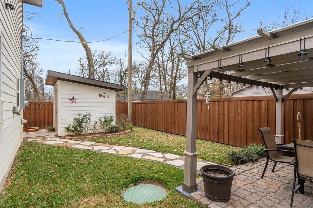 6156 Inca Drive Mabank, TX 75156 - Photo 29 of 30 a view of a backyard with table and chairs and wooden fence