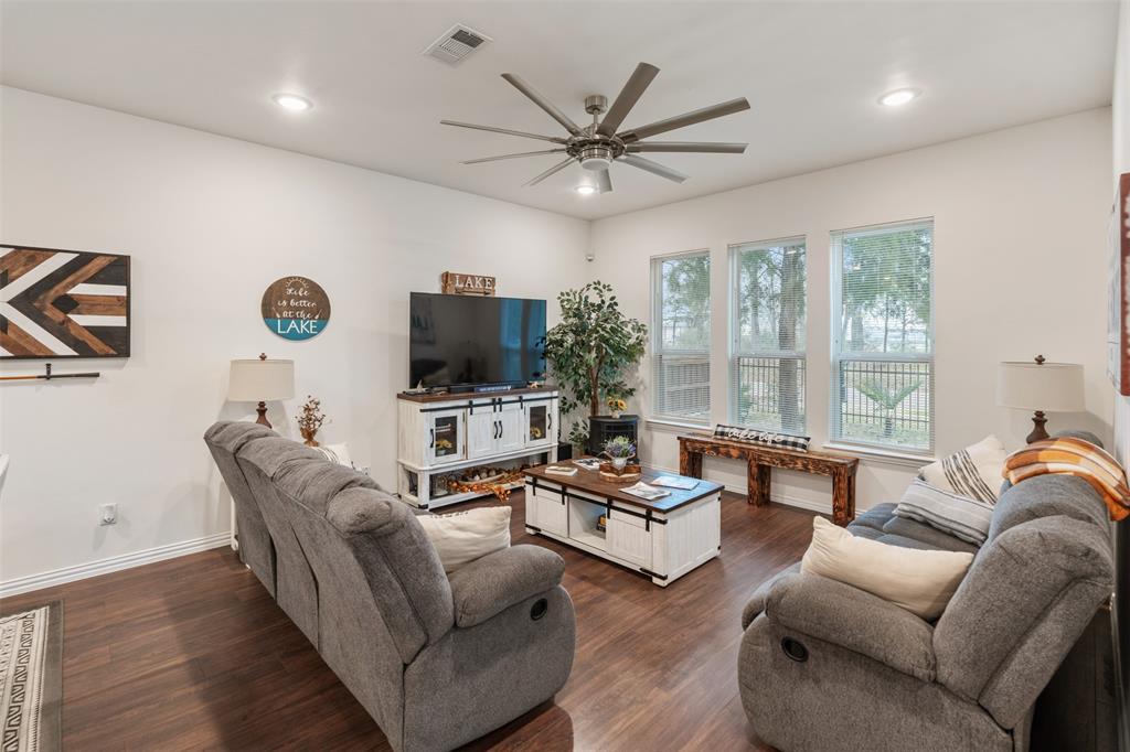 6156 Inca Drive Mabank, TX 75156 - Photo 6 of 30 a living room with furniture a flat screen tv and a large window