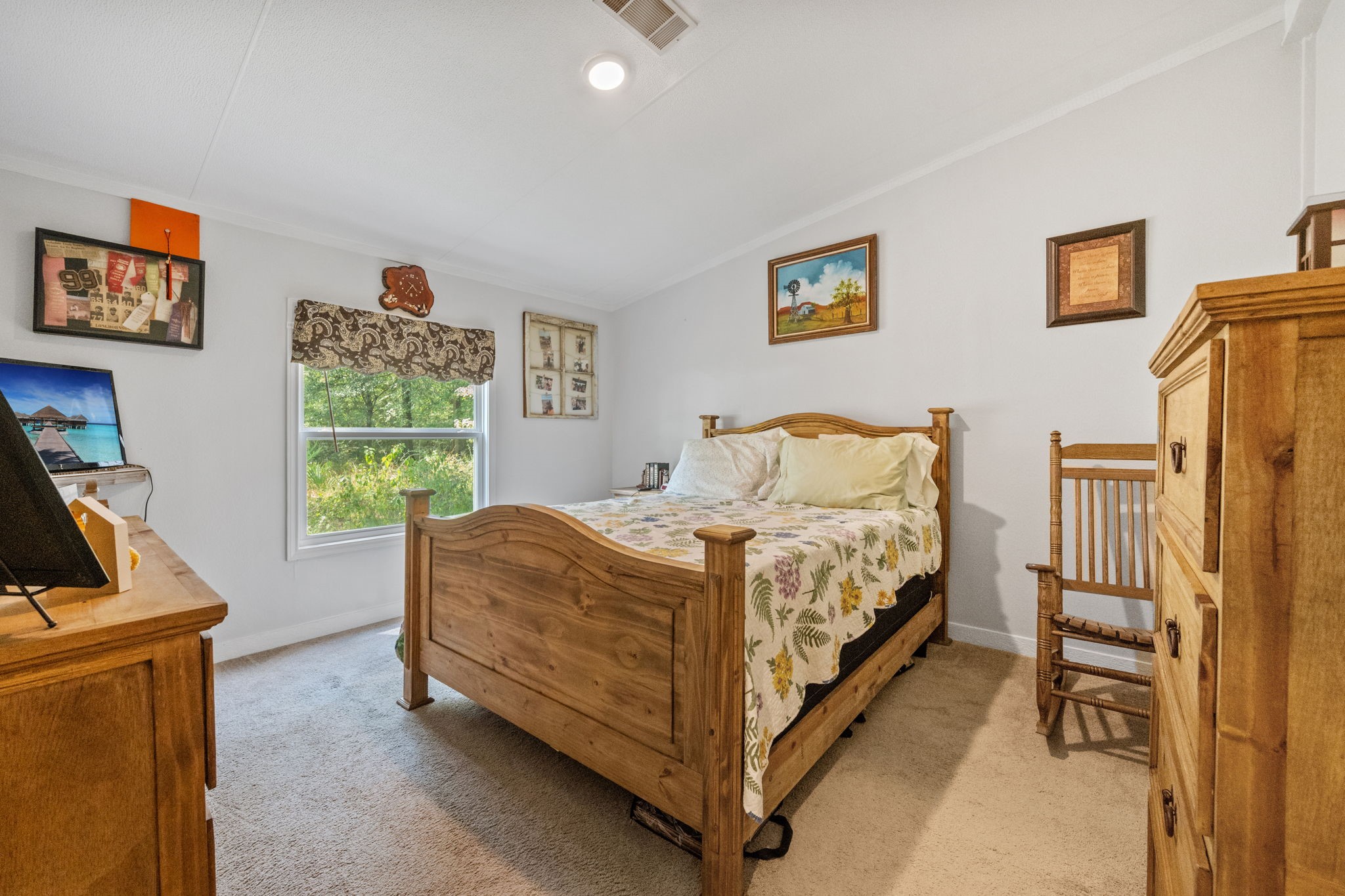 161 W Creek Trinity, TX 75862 - Photo 15 of 22 a bed sitting in a bedroom next to a window