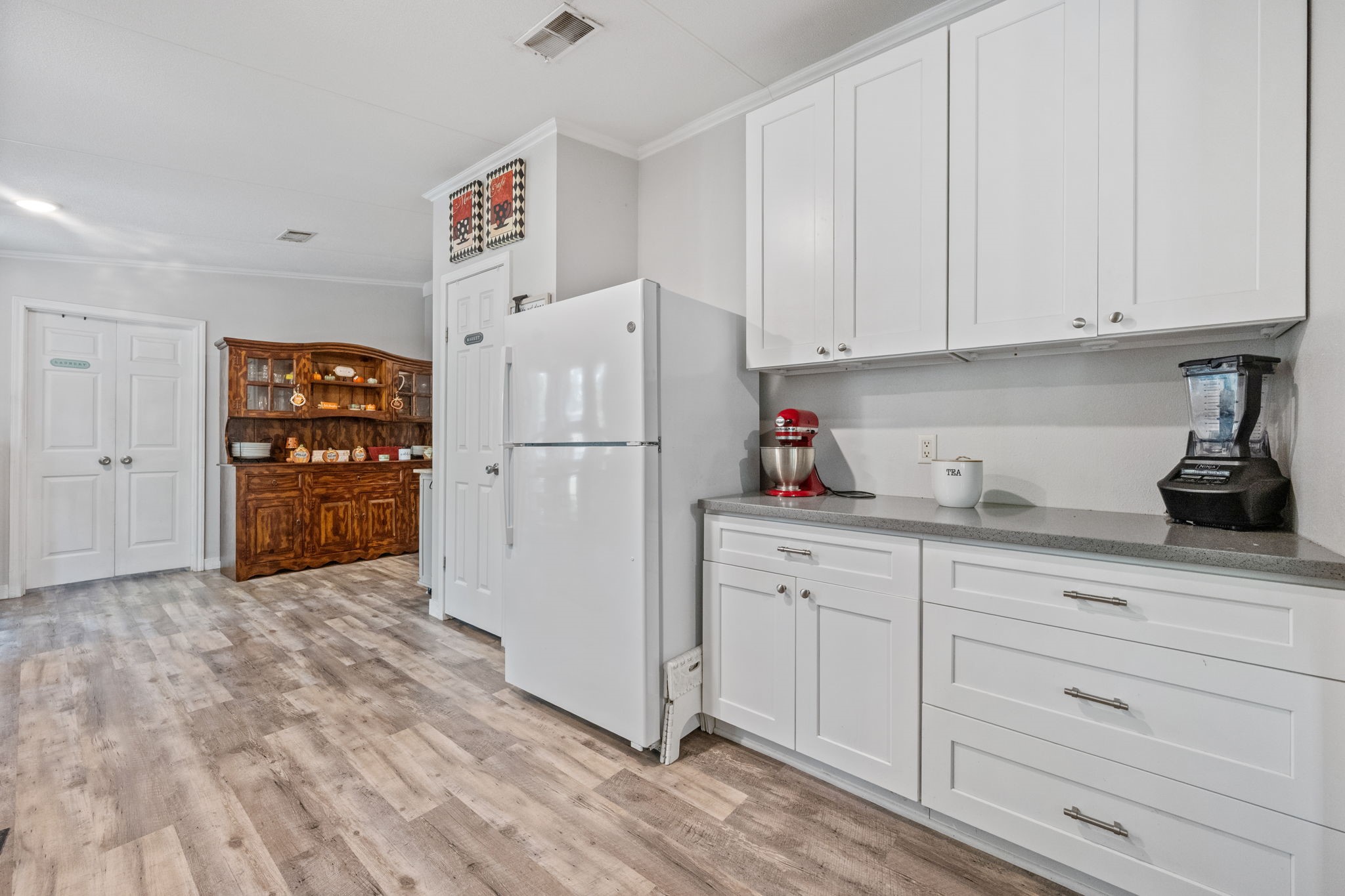 161 W Creek Trinity, TX 75862 - Photo 9 of 22 a kitchen with white cabinets and refrigerator