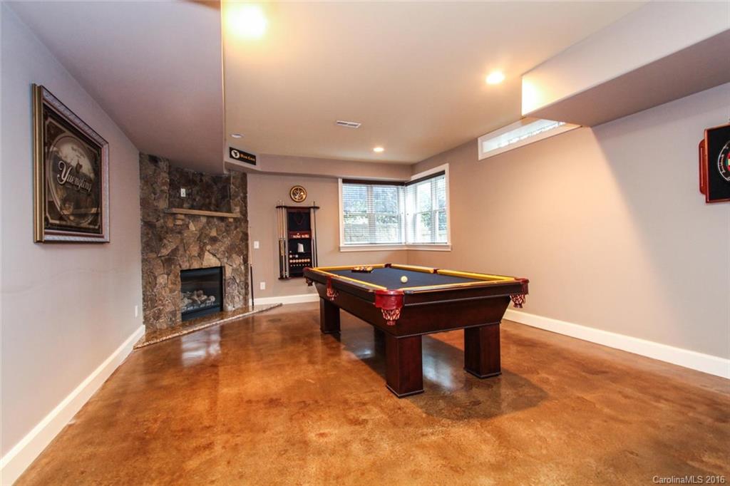 7227 Sheffingdell Drive Charlotte, NC 28226 - Photo 22 of 24 a room with pool table and a fireplace