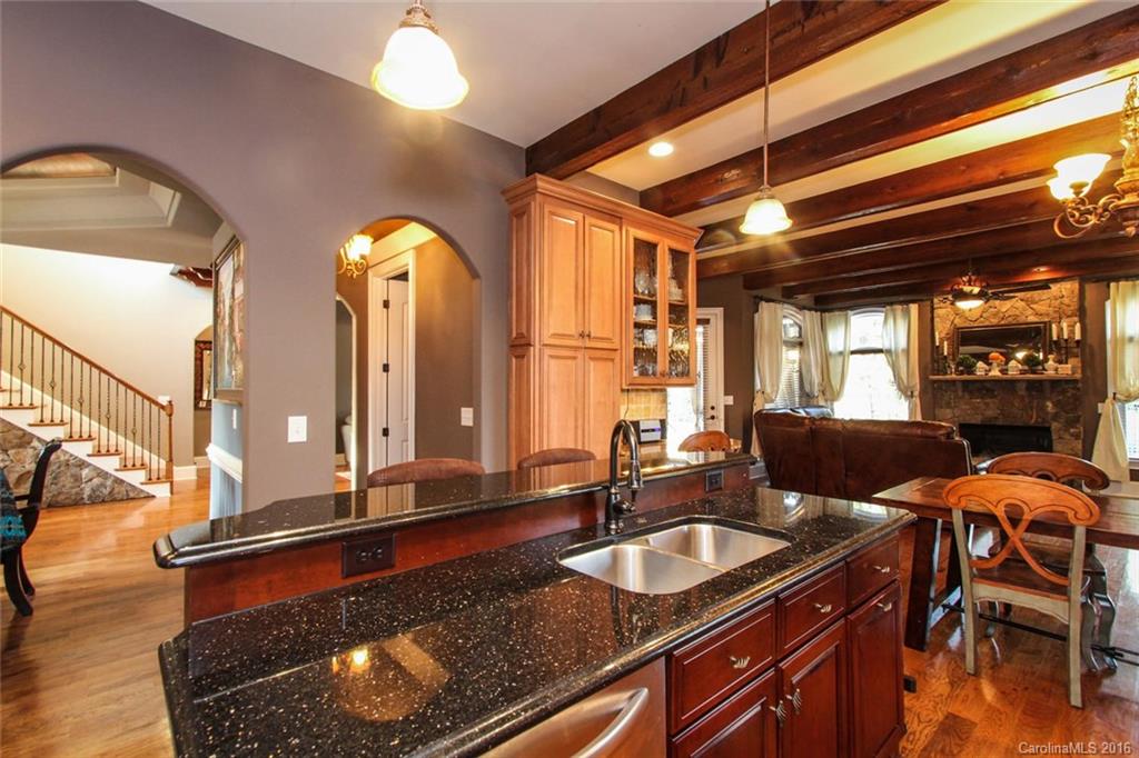 7227 Sheffingdell Drive Charlotte, NC 28226 - Photo 4 of 24 a kitchen with a sink and living room