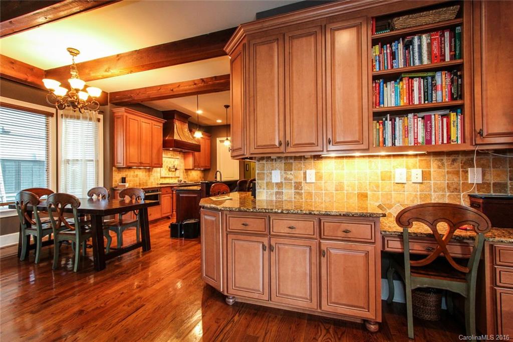 7227 Sheffingdell Drive Charlotte, NC 28226 - Photo 6 of 24 a kitchen with stainless steel appliances granite countertop a stove and cabinets