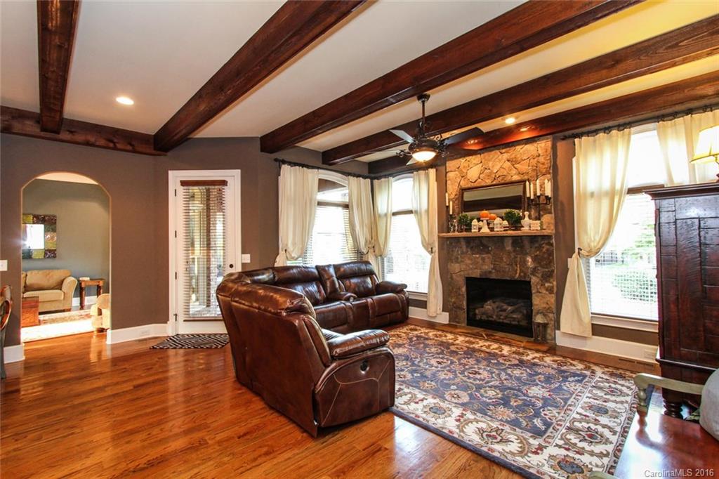 7227 Sheffingdell Drive Charlotte, NC 28226 - Photo 7 of 24 a living room with furniture fireplace and wooden floor