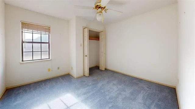 an empty room with windows and cabinet