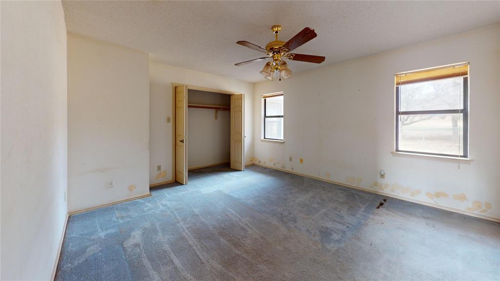 8927 Bontura Road Granbury, TX 76049 - Photo 16 of 23 an empty room with windows and fan