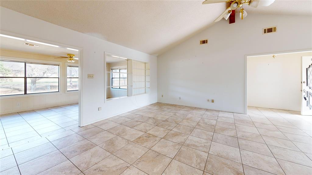 8927 Bontura Road Granbury, TX 76049 - Photo 5 of 23 a view of an empty room with a window