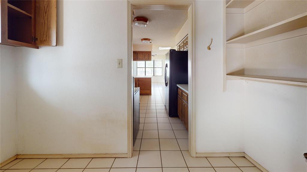 8927 Bontura Road Granbury, TX 76049 - Photo 6 of 23 a view of a kitchen from the hallway