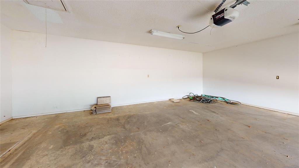 8927 Bontura Road Granbury, TX 76049 - Photo 9 of 23 a view of a garage and hardwood floor