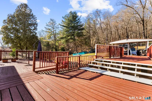 a view of a roof deck with wooden floor and fence