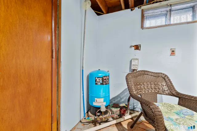 a view of a workspace with furniture and a window