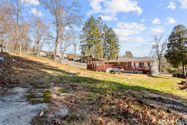 a view of a house with a yard covered in snow