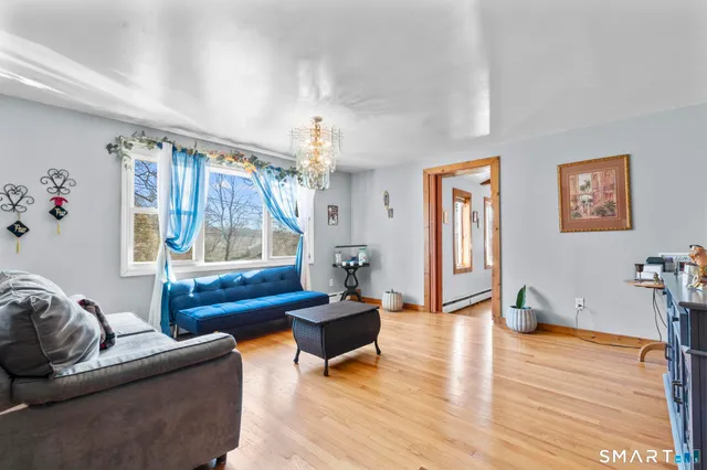 a kitchen with stainless steel appliances granite countertop a sink a stove a refrigerator cabinets and a window