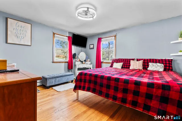 a bed sitting in a bedroom next to a window