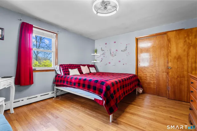 a bed sitting in a bedroom next to a window