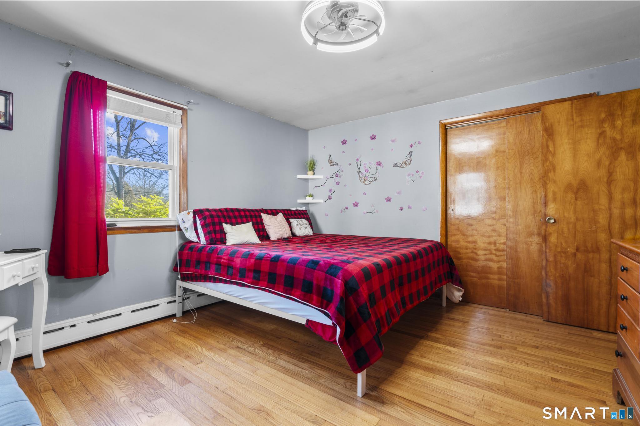 208 Bungay Road Seymour, CT 06483 - Photo 9 of 28 a bed sitting in a bedroom next to a window