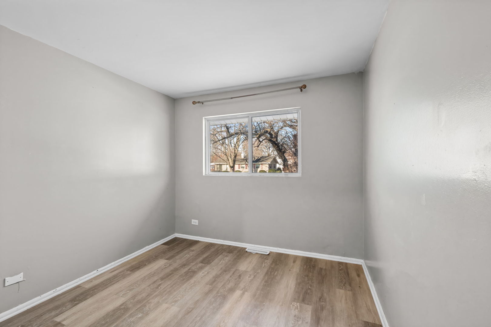 18945 West Old Plank Road Grayslake, IL 60030 - Photo 11 of 21 a view of an empty room with wooden floor and a window