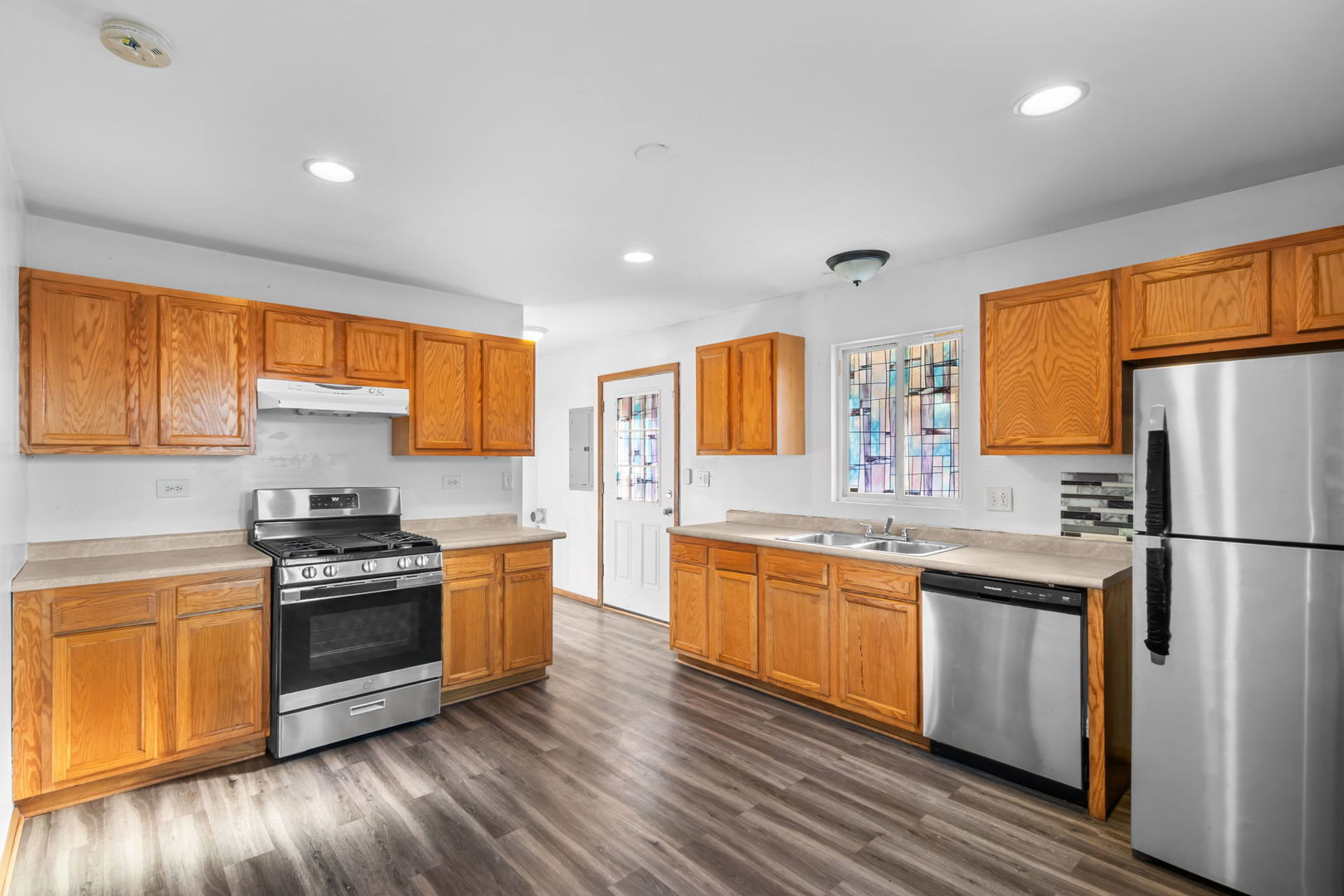 18945 West Old Plank Road Grayslake, IL 60030 - Photo 6 of 21 a kitchen with stainless steel appliances a stove a sink and a refrigerator