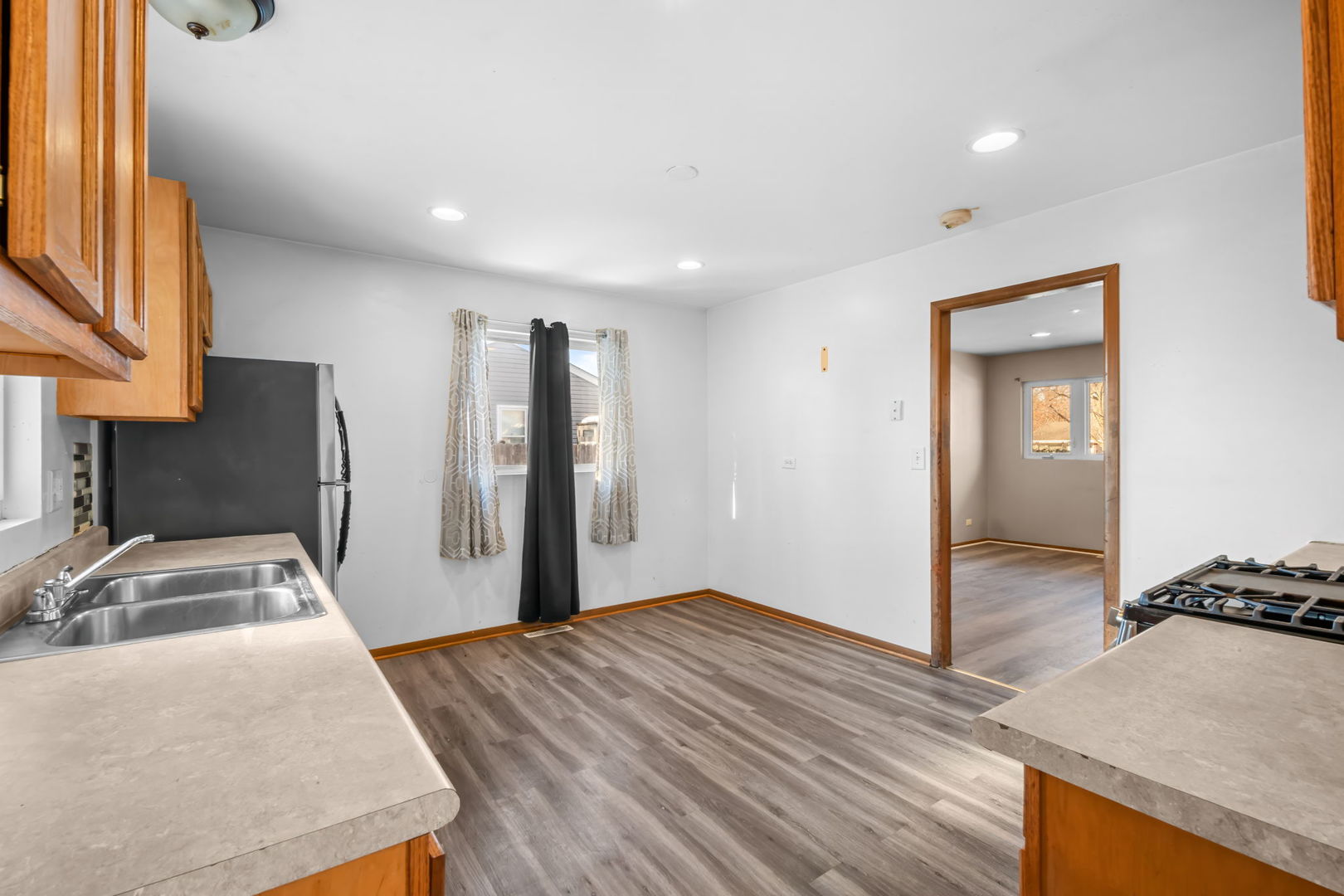 18945 West Old Plank Road Grayslake, IL 60030 - Photo 8 of 21 a room with a bed and a refrigerator