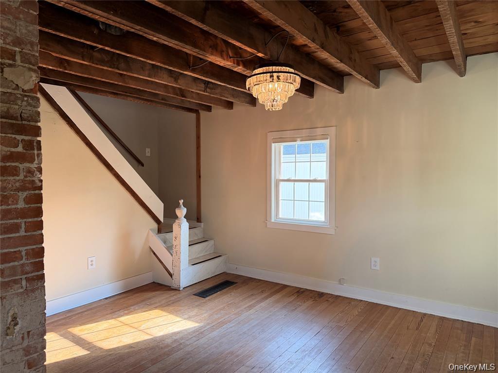 265 Maybrook Road Campbell Hall, NY 10916 - Photo 11 of 20 a view of an empty room with wooden floor and stairs