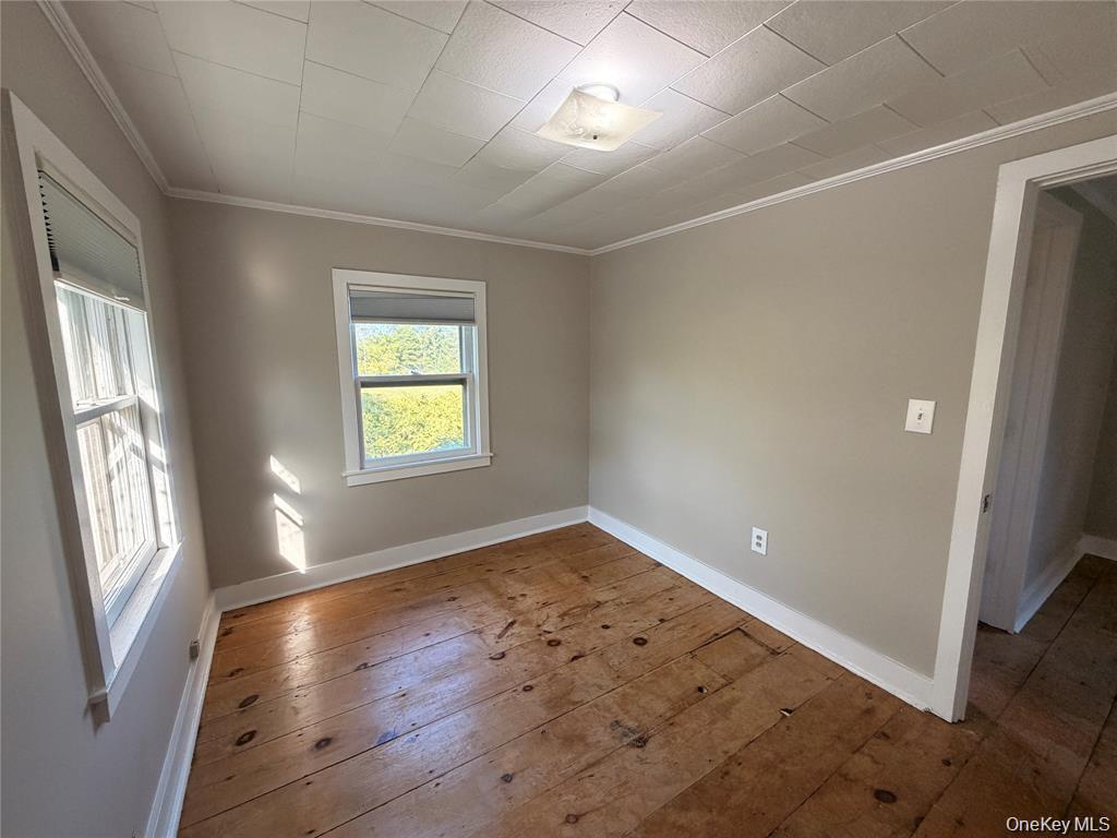 265 Maybrook Road Campbell Hall, NY 10916 - Photo 15 of 20 wooden floor in an empty room with a window